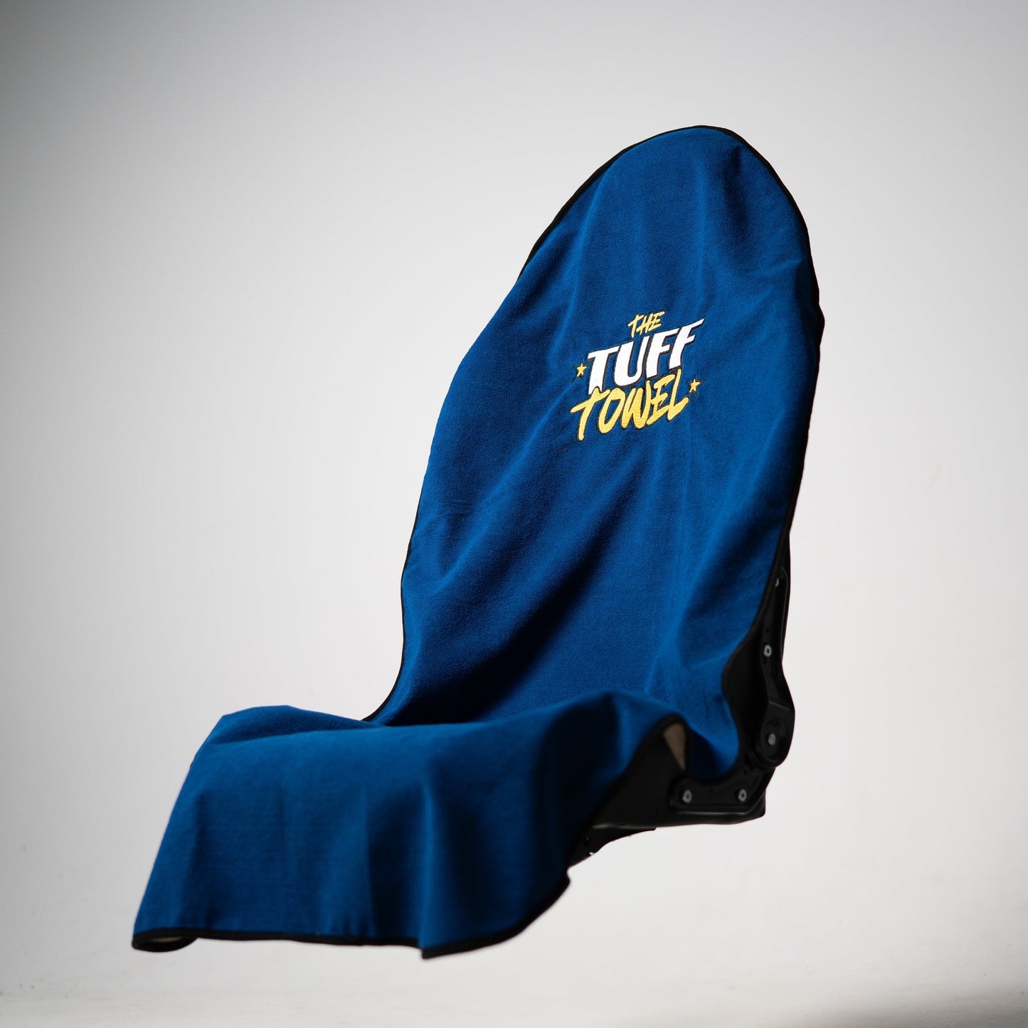 Blue Tuff Towel protecting gym bench from sweat and dirt during a workout.