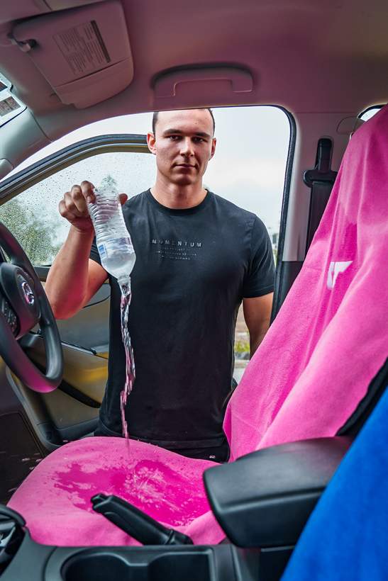Water poured on a Tuff Towel seat cover showing it is waterproof